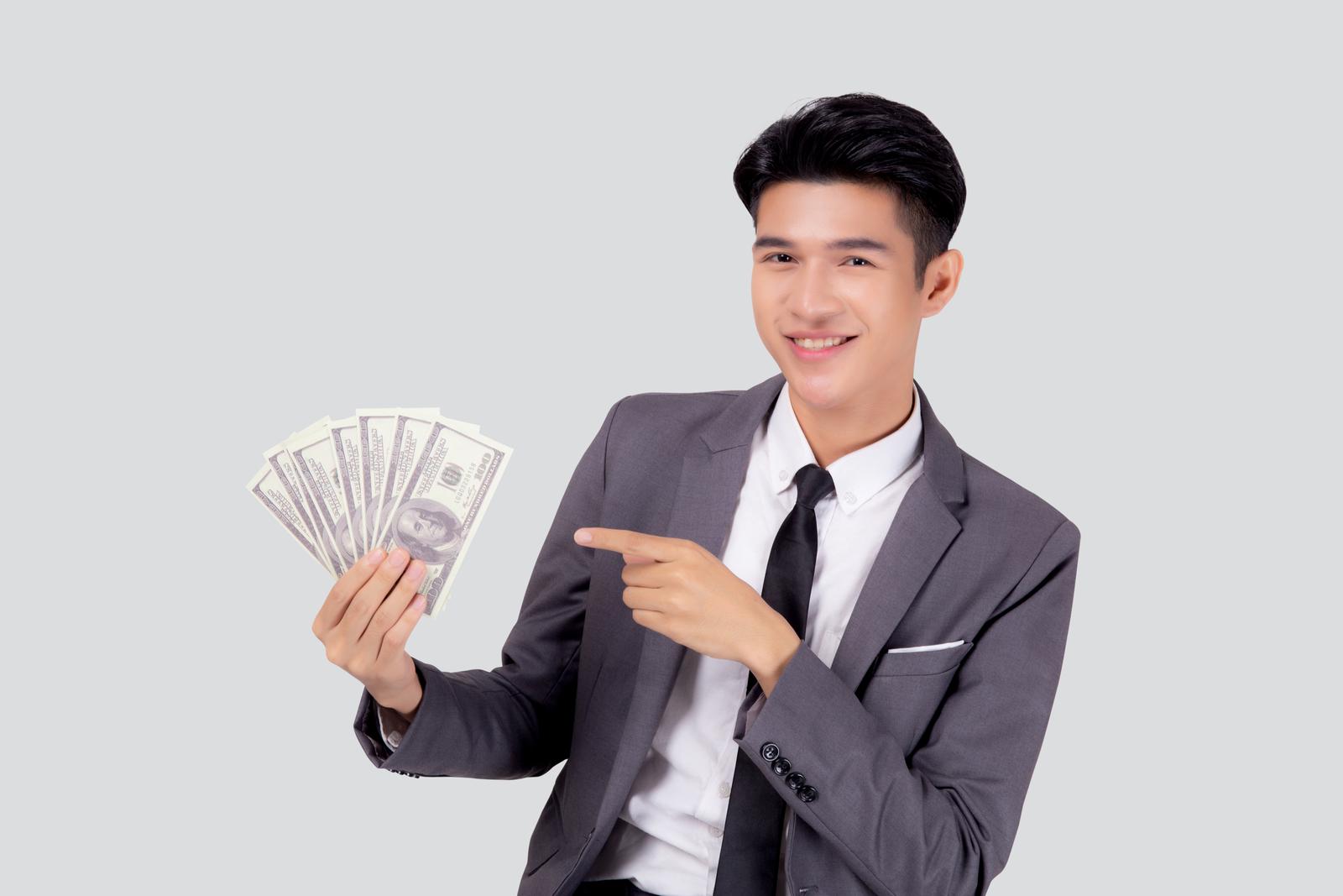 Young asian business man holding money