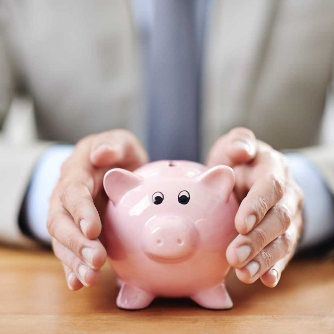 Man Holding Piggy Bank